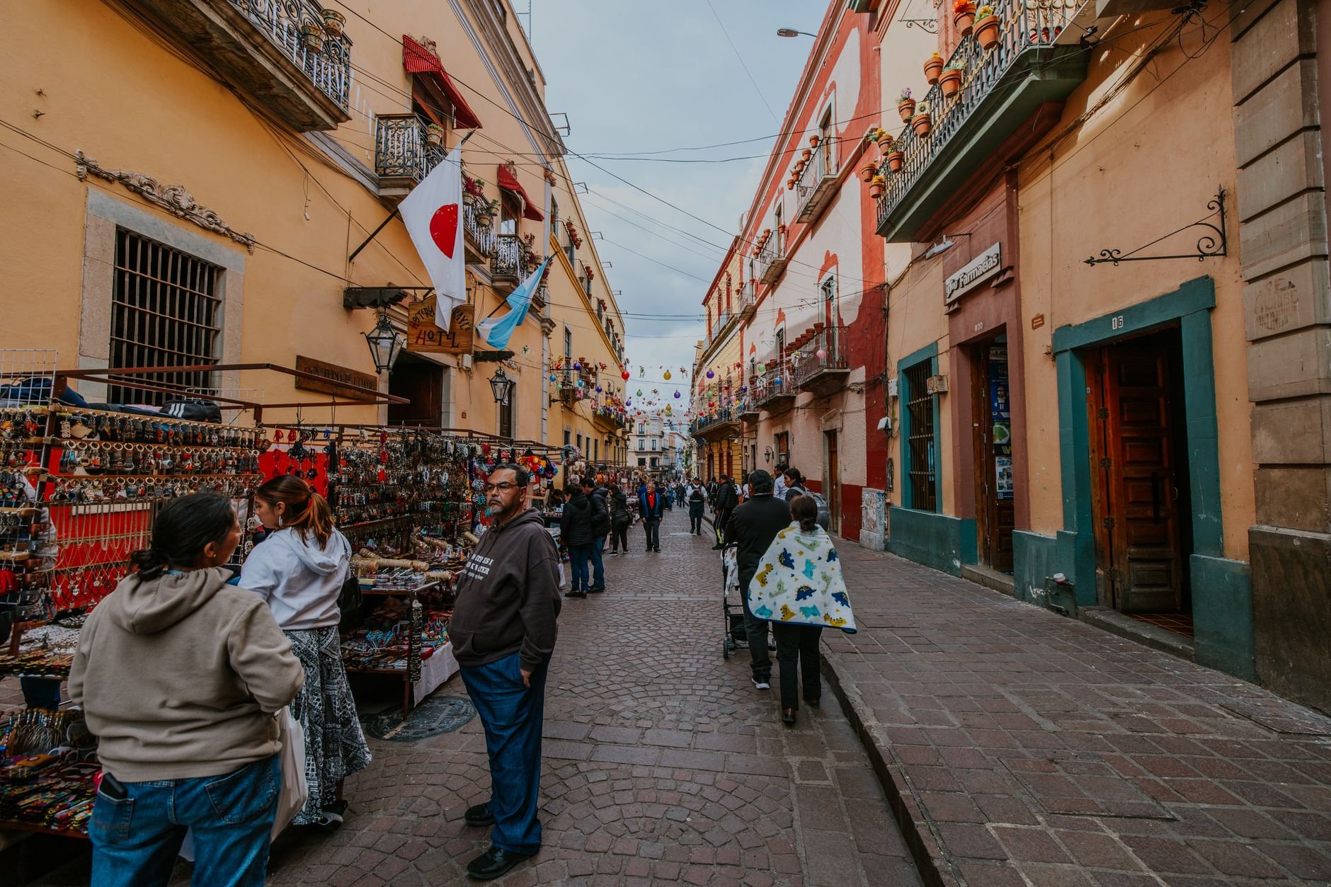 Explore the bustling street market in Guanajuato, Mexico, showcasing colorful architecture and local life.